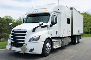 White Freightliner Cascadia 116 Custom Expediter truck parked on the street.