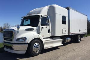 White Freightliner M2 112 Custom Expediter truck parked on the street.